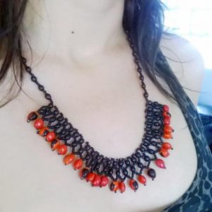 Huayruro necklace and achira